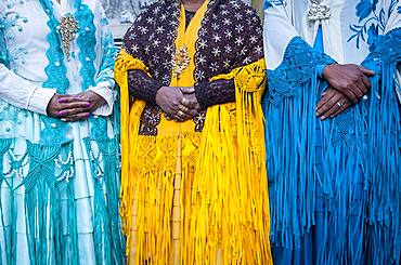 Detail of dresses and hands. At left Benita la Intocable , in the middle Angela la Folclorista, and at right Dina, cholitas females wrestlers, El Alto, La Paz, Bolivia