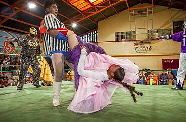 Lucha Libre. male and the cholita Celia la Simpatica wrestlers in combat, Sports center La Ceja, El Alto, La Paz, Bolivia