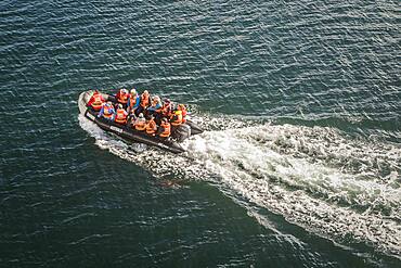 Explorers riding a zodiac, in Seno Almirantazgo, PN Alberto de Agostini, Tierra del Fuego, Patagonia, Chile