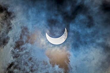 The partial eclipse of the Sun, October 23, 2014, as seen from Jasper, Alberta, in this case shot through thin cloud but that makes for a more interesting photo than one in a clear sky. This is still shot through a mylar filter, on the front of a 66mm f/6 apo refractor using the Canon 60Da for 1/25 sec exposure at ISO 100. The colours are natural, with the mylar filter providing a neutral 'white light' image. With the Sun dimmed a lot by cloud, the longer exposure allowed picking up light and colours in the surrounding clouds.