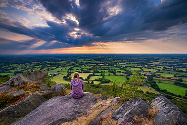 A girl looks out over the Cheshire Plain from Bosley Cloud, Cheshire, England, United Kingdom, Europe