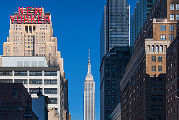 The New Yorker Hotel and Empire State Building viewed along 34th Street, Garment District, Manhattan, New York, United States of America, North America