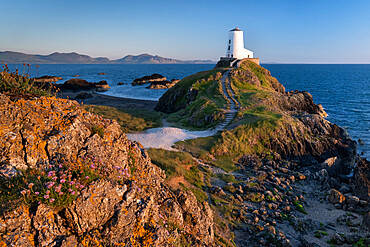 Twr Mawr lighthouse on Llanddwyn Island backed by the Lleyn Peninsula, near Newborough, Anglesey, North Wales, United Kingdom, Europe