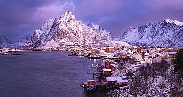 The fishing village of Reine and Olstinden mountain at dawn in winter, Moskenes Municipality, Nordland County, Lofoten Islands, Norway, Scandinavia, Europe