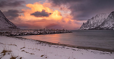 Panoramic image of Ersfjorden and The Devils Teeth viewed from Ersfjordstranda beach at sunset in winter, Senja, Troms og Finnmark County, Norway, Scandinavia, Europe