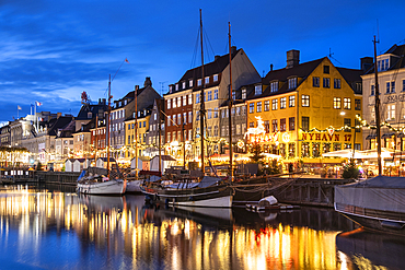 Colourful buildings and tall masted boats on the waterfront at Nyhavn at night, Nyhavn Canal, Nyhavn, Copenhagen, Denmark, Europe