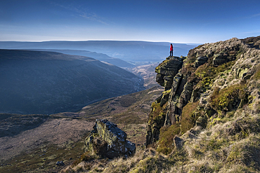 Walker looking over Crowden Great Brook valley from Laddow Rocks, Peak District National Park, Derbyshire, England, United Kingdom, Europe