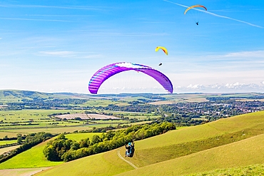 Paragliders at Mount Caburn, flying over the County town of Lewes, East Sussex, England, United Kingdom, Europe