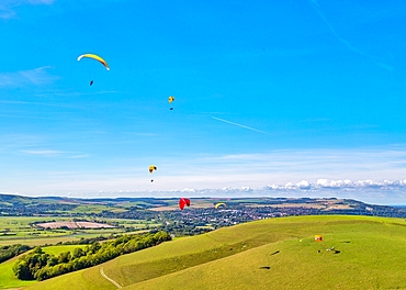 Paragliders at Mount Caburn, flying over the County town of Lewes, East Sussex, England, United Kingdom, Europe