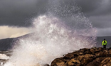 Breezy day from West Shore, waves crashing against the coast with Black Combe and the English Lake District in the distance, Walney Island, Cumbria, England, United Kingdom, Europe