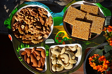 Dry fruits  and nuts like almonds,cashews and walnut kernels along with chiki in a tray, Mandi, Kerala, India, Asia