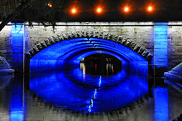 Floodlit Brividas bridge over the Canal surrounding the Old Town of Riga, Latvia, Baltic region, Europe