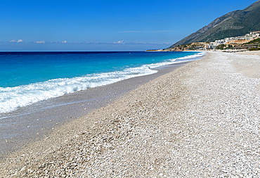 Ionian Sea, Drymades Beach, with large scale tourist development construction building work in the distance, Albanian Riviera, Dhermi, Albania, Europe