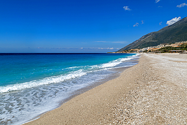 Ionian Sea, Drymades Beach, with large scale tourist development construction building work in the distance, Albanian Riviera, Dhermi, Albania, Europe