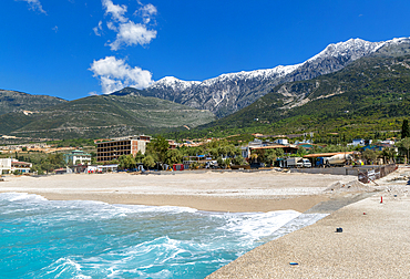 Tourist development construction building work view from Drymades beach to Mount Cika snow capped mountain range, Dhermi, Albanian Riviera, Albania, Europe