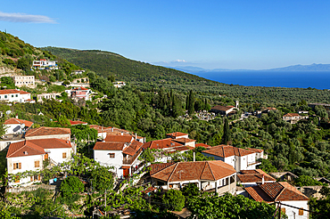 View over rooftops of homes in village of Vuno, towards Ionian Sea, near Himare, Albania, Europe