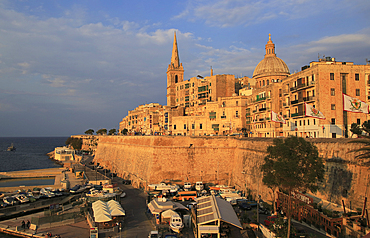 Golden warm evening light on buildings and churches, including dome of Our Lady of Mount Carmel church, UNESCO World Heritage Site, Valletta, Malta, Mediterranean, Europe