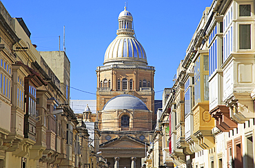 Traditional houses with balconies and dome of Paola Parish Church, Tarxien town, near Valletta, Malta, Mediterranean, Europe