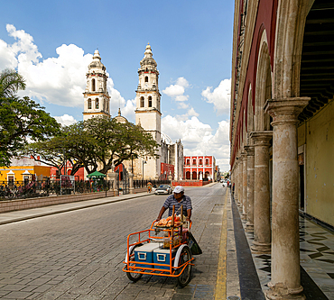 Man pushing cart in main square of Campeche city, Campeche State, Mexico, North America