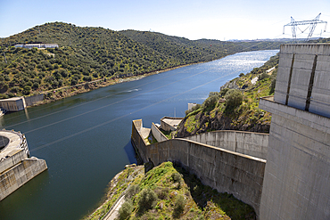 Barragem do Alqueva dam, part of the multipurpose water management project on the Rio Guadiana river, hydro-electricity generation electricity power lines, Moura, Portugal, Europe