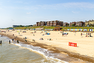 People enjoying sunny weather on sandy South Beach, Lowestoft, Suffolk, England, UK