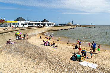 Families enjoying sunny summer weather on South Pier beach, Lowestoft, Suffolk, England, UK