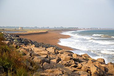 North Sea coastline view of rock armour and beach bar north to Shingle Street, East Lane, Bawdsey, Suffolk, England, UK