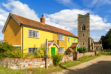 Historic cottages next to village parish church of All Saints, Rede, Suffolk, England, UK