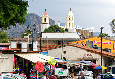 View over street market to historic church Ex Convento Dominico de la Natividad, Tepoztlan, State of Morelos, Mexico, North America