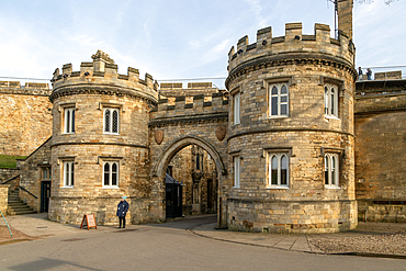 Entrance gateway to Lincoln castle, city of Lincoln, Lincolnshire, England, UK people walking on medieval wall