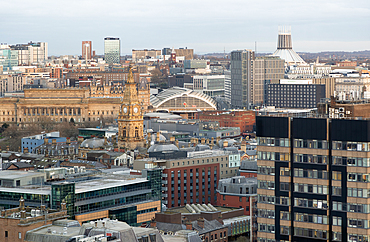 View over city centre rooftops to Lime Street railway station and the Catholic cathedral, Liverpool, England, UK