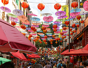 Red paper Chinese lanterns and umbrellas hanging above the street advertising various restaurants, in Chinatown, Mexico City, Mexico, North America