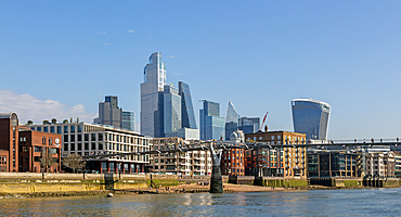 Millennium Bridge with skyscrapers of City of London, River Thames, London, England, UK