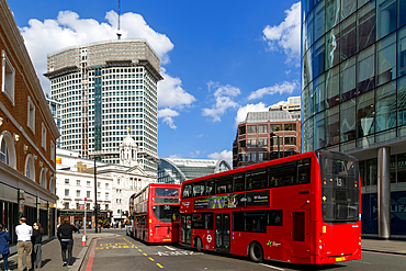Red double-decker buses in street by Victoria palace theatre, Victoria, Westminster, London, England, UK