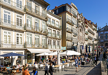 People sitting at cafe tables outside historic buildings, Praça de Almeida Garrett, Rua das Flores, Porto, Portugal, Europe