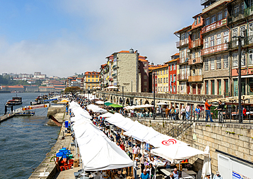 Market stalls selling tourist souvenirs, River Douro waterfront, Ribeira district, city of Porto, Portugal, Europe