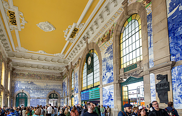 Tour groups viewing historic azulejos tiles, Sao Bento railway station building, city of Porto, Portugal, Europe