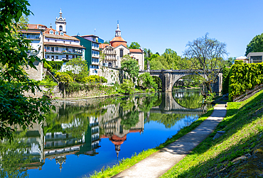Historic buildings reflected in water of River Tamega, Amarante, Tâmega e Sousa, Portugal, Europe