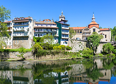 Historic buildings reflected in water of River Tamega, Amarante, Tâmega e Sousa, Portugal, Europe