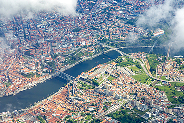 Oblique aerial view from plane window, Dom Luis I Bridge crossing River Douro, city centre of Porto, Portugal, Europe