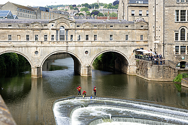 Avon Fire and Rescue Service personnel on weir on River Avon, Pulteney Bridge, city of Bath, north east Somerset, England, UK