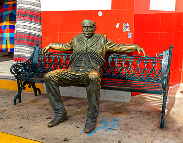 Sculpture of seated Mexican bandit, with part of head missing, Isla Mujeres, Caribbean Coast, Cancun, Quintana Roo, Mexico, North America