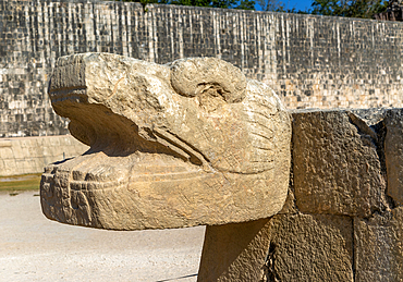 Carved stonework jaguar head with walls of the ball court, Juego de Pelota, Mayan ruins, Chichen Itza, UNESCO World Heritage Site, Yucatan, Mexico, North America