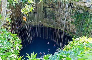 People swimming in limestone sinkhole pool, Cenote Ik kil, Piste, Yucatan, Mexico, North America