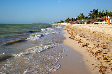 Sandy beach and waves sea of Gulf of Mexico, coastal fishing settlement of Celestun, Yucatan, Mexico, North America