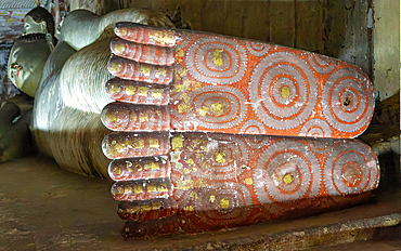 Feet of Buddha figure inside Dambulla cave Buddhist temple complex, UNESCO World Heritage Site, Sri Lanka, Asia