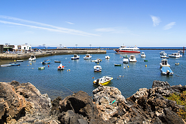 Harbour and ferry boat in the fishing village of Orzola, Lanzarote, Canary Islands, Spain, Atlantic, Europe