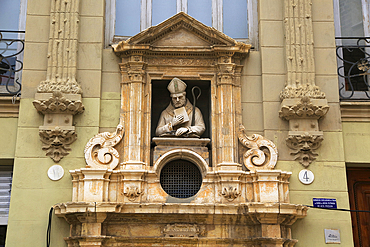 Statue of Christian bishop, carved stonework of the Cathedral Church building in city of Valencia, Spain, Europe