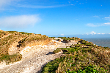 Coastal landscape with sandy dunes and a clear blue sky on a sunny day, Hastings, East Sussex, England, United Kingdom, Europe