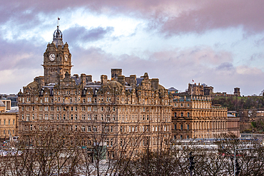 Historic building with clock tower against a cloudy sky at dusk, Edinburgh, Scotland, United Kingdom, Europe